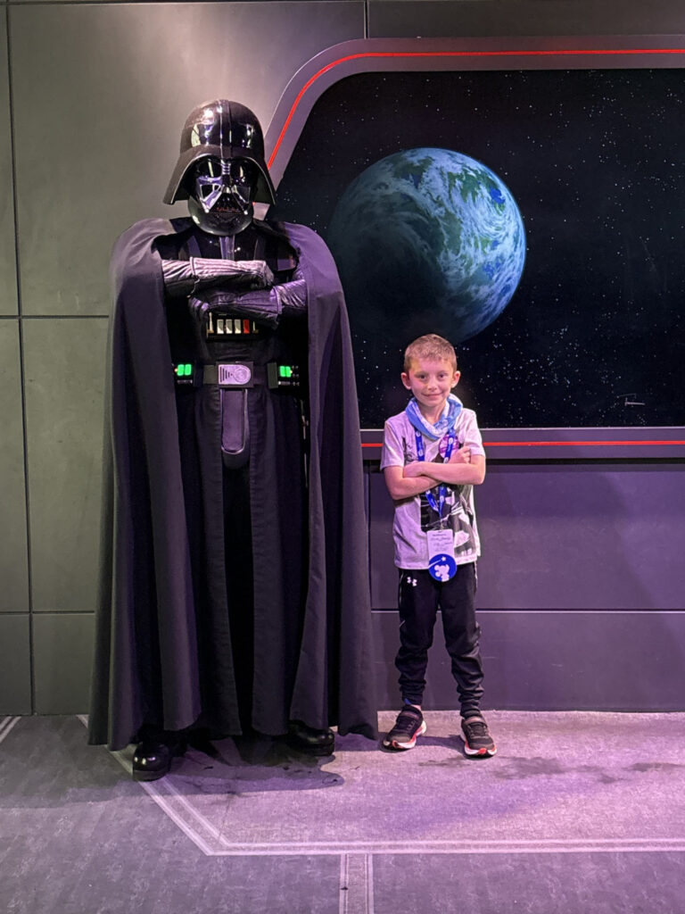 young boy with darth vader on board a spaceship set